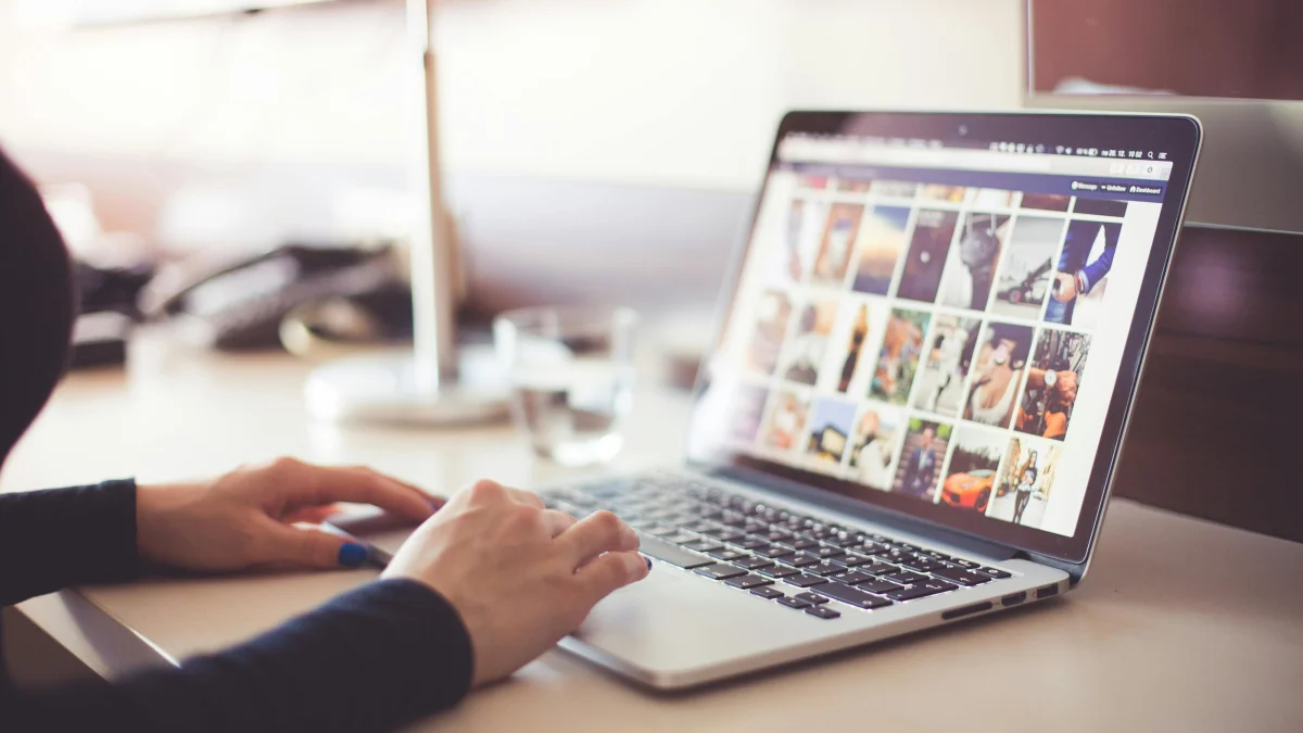 A woman working on a macbook