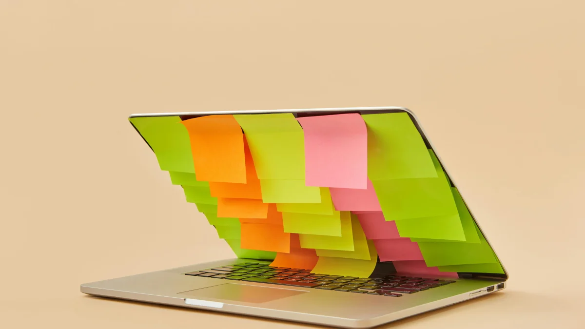 A Macbook with sticky notes on its screen