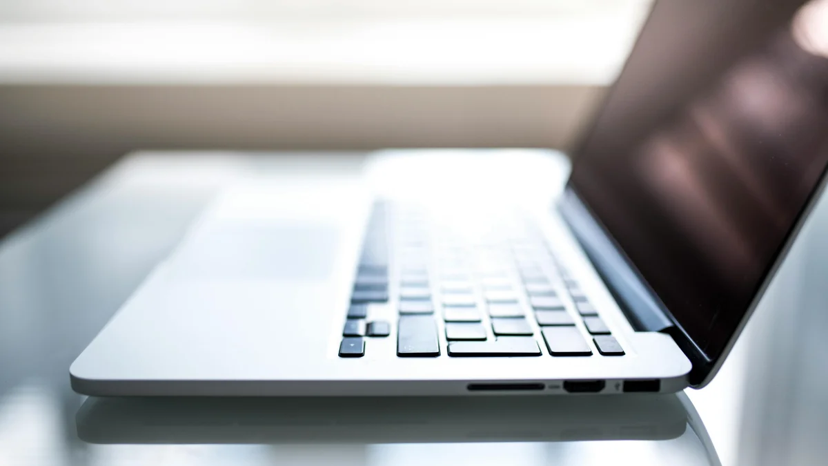 Side of Macbook on a shiny table