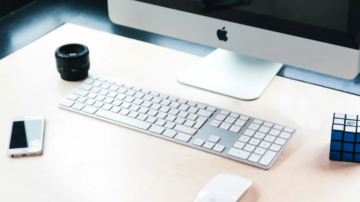 Magic Keyboard and mouse and other accessories on a wooden top table