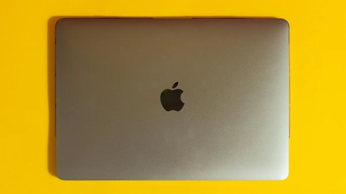 A macbook on yellow background